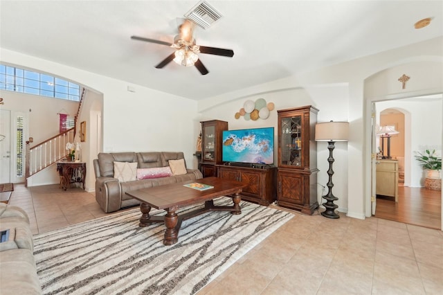 living room featuring ceiling fan and light tile floors