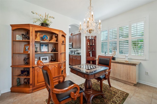 dining area with an inviting chandelier and light tile floors