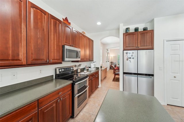 kitchen featuring stainless steel appliances and light tile floors