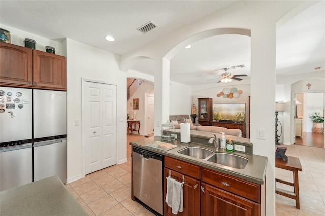 kitchen featuring sink, ceiling fan, light tile floors, and stainless steel appliances