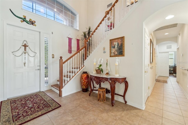 entrance foyer featuring a high ceiling and light tile flooring