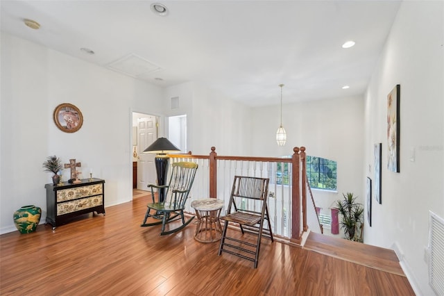 living area with hardwood / wood-style flooring