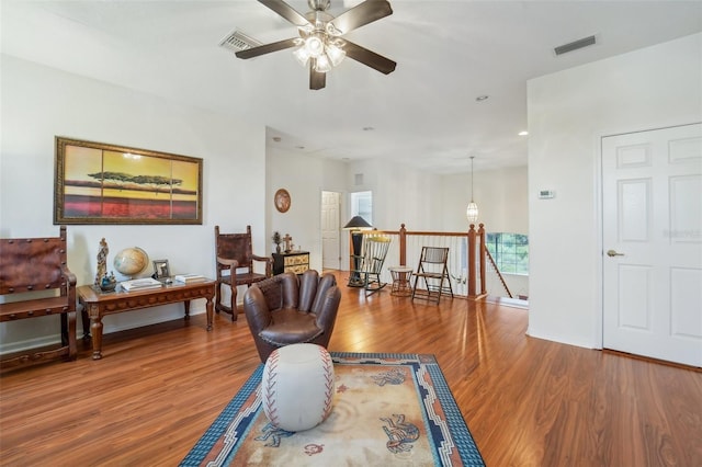 interior space with wood-type flooring and ceiling fan