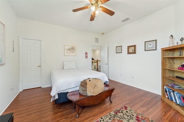 bedroom with ceiling fan and dark wood-type flooring