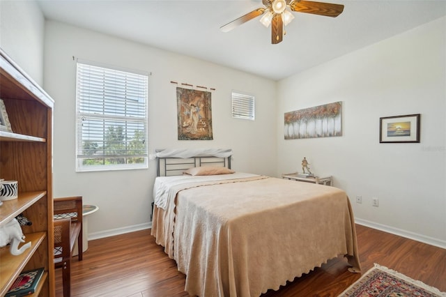 bedroom with dark hardwood / wood-style floors and ceiling fan