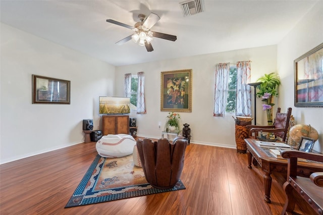 living area featuring ceiling fan and hardwood / wood-style floors