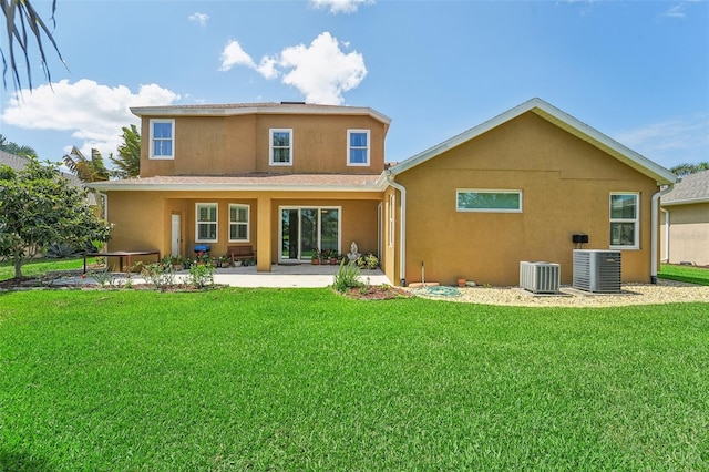 rear view of property featuring a patio, a lawn, and central air condition unit