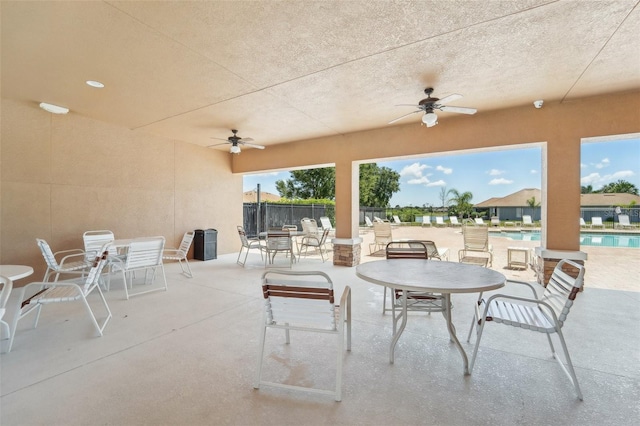 view of terrace with a community pool and ceiling fan