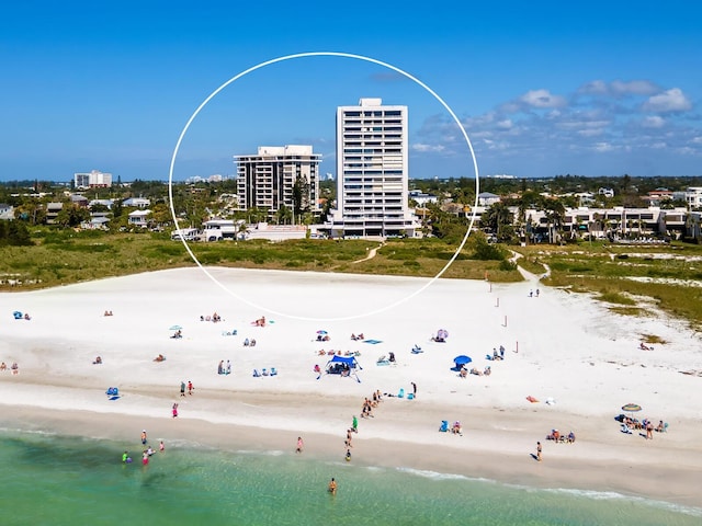 bird's eye view featuring a view of the beach and a water view