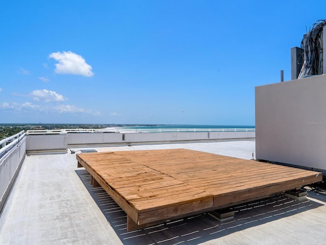 view of patio / terrace with a balcony and a water view