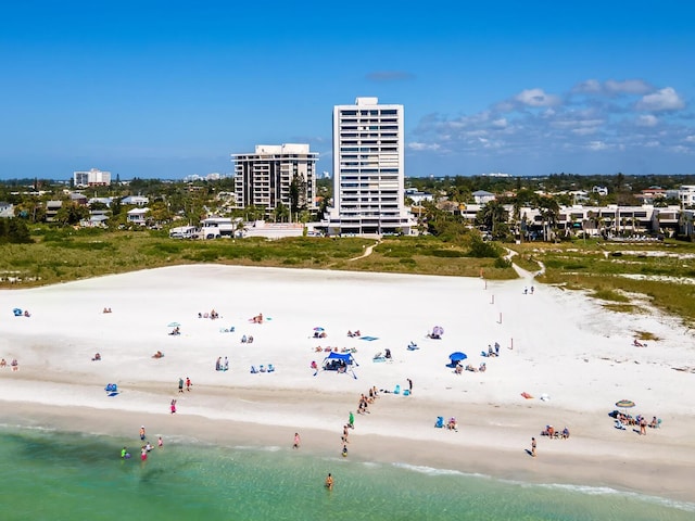 drone / aerial view with a water view and a view of the beach