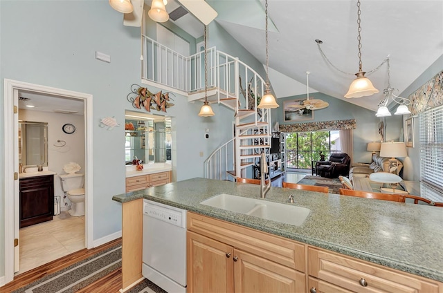 kitchen featuring light brown cabinets, tile flooring, decorative light fixtures, white dishwasher, and high vaulted ceiling