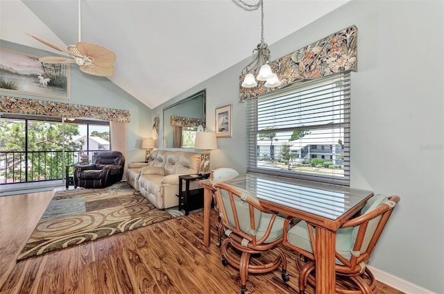 dining space with ceiling fan, lofted ceiling, and wood-type flooring