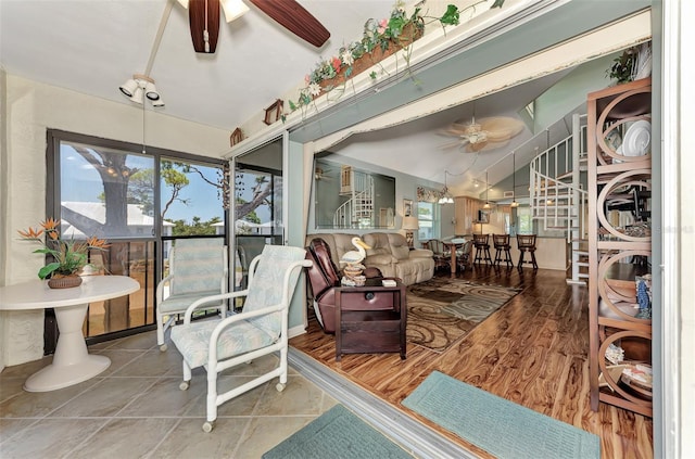 sunroom / solarium featuring a healthy amount of sunlight and ceiling fan