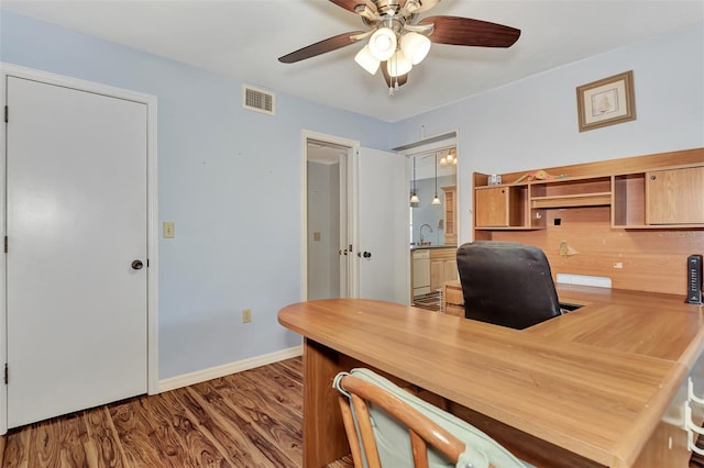 office with ceiling fan and dark hardwood / wood-style flooring