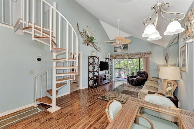 living room with high vaulted ceiling, wood-type flooring, and ceiling fan with notable chandelier