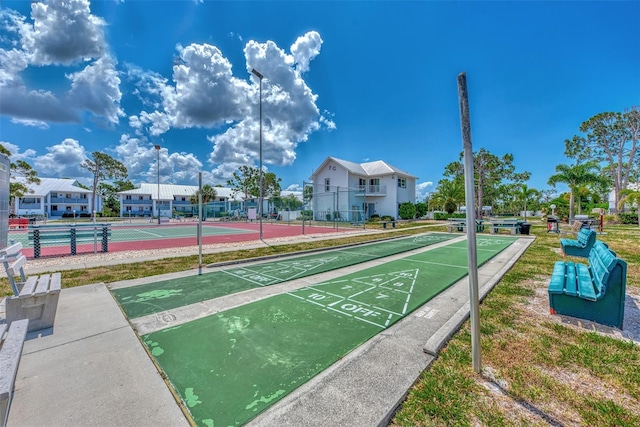 surrounding community with tennis court