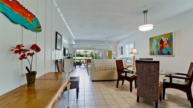 tiled dining room featuring ceiling fan and a textured ceiling