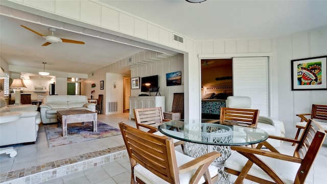 tiled dining area featuring ceiling fan