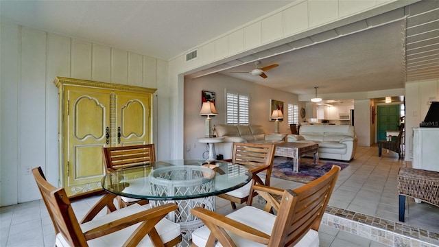 tiled dining room featuring ceiling fan