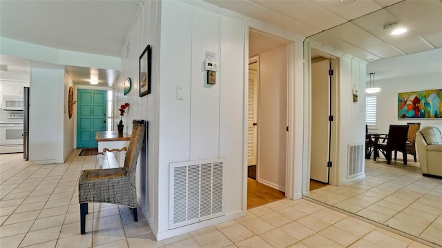 hallway featuring light tile patterned floors