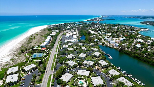 bird's eye view featuring a water view and a view of the beach