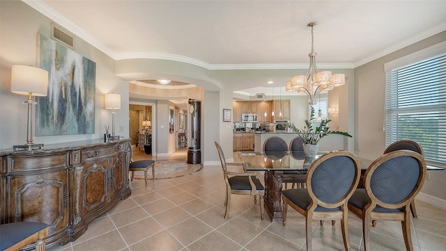 dining room with crown molding and light tile patterned flooring