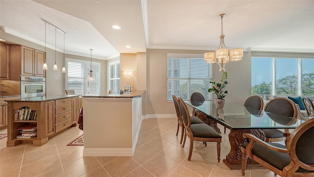 dining area with a chandelier, ornamental molding, light tile patterned floors, and a wealth of natural light