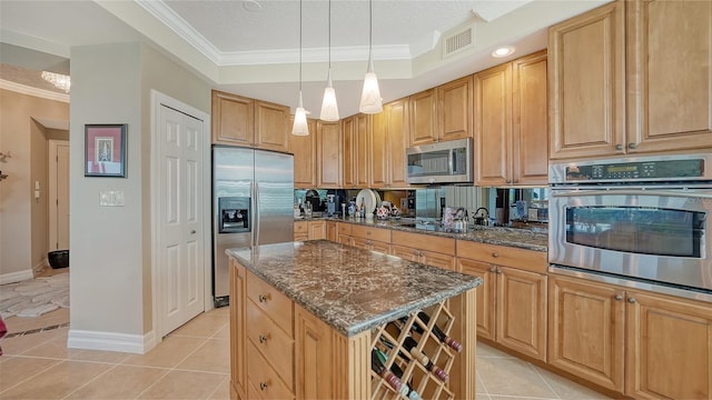 kitchen with a center island, light tile patterned flooring, dark stone countertops, pendant lighting, and appliances with stainless steel finishes