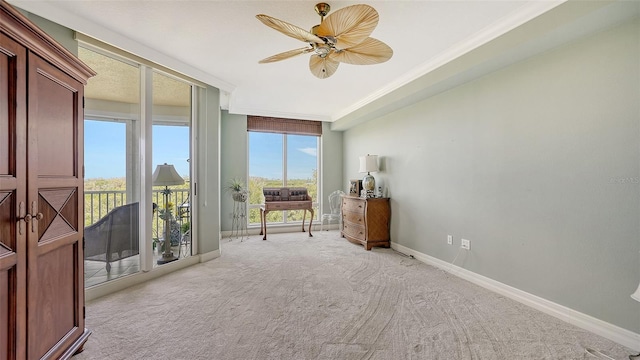 carpeted bedroom featuring ceiling fan, access to outside, crown molding, and expansive windows