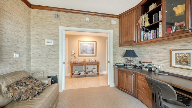 carpeted office space with built in desk and crown molding