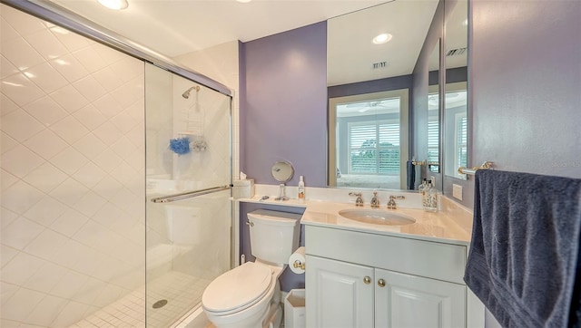 bathroom featuring toilet, walk in shower, and vanity