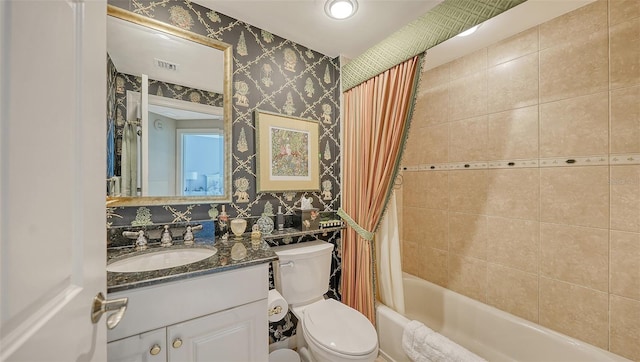 full bathroom with shower / bath combo with shower curtain, vanity, and toilet