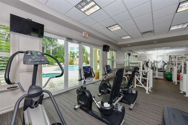 exercise room featuring a drop ceiling