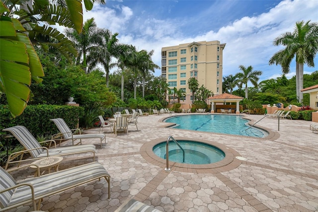 view of swimming pool with a community hot tub and a patio