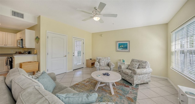 tiled living room featuring ceiling fan