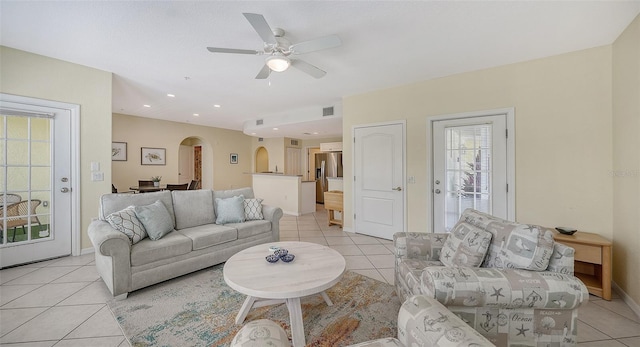 living room with ceiling fan and light tile floors