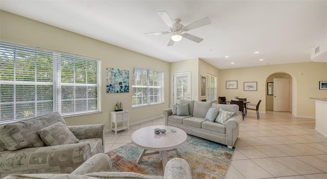 tiled living room featuring ceiling fan