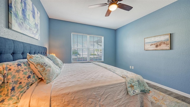 bedroom with ceiling fan and hardwood / wood-style flooring