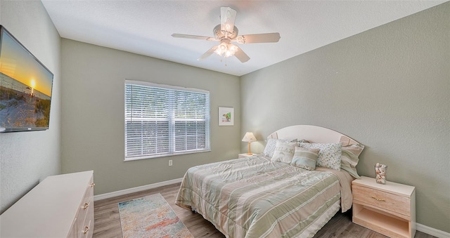 bedroom featuring dark hardwood / wood-style flooring and ceiling fan