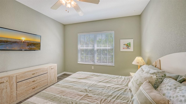 bedroom with hardwood / wood-style floors and ceiling fan