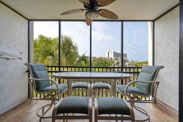 sunroom / solarium featuring ceiling fan