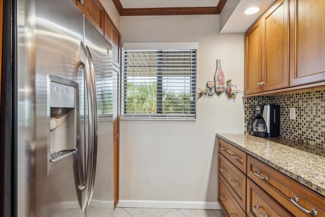 kitchen with stainless steel fridge with ice dispenser, backsplash, light stone countertops, ornamental molding, and light tile floors