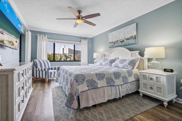 bedroom featuring ceiling fan, ornamental molding, and dark hardwood / wood-style flooring