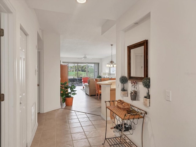 hall featuring light tile patterned floors