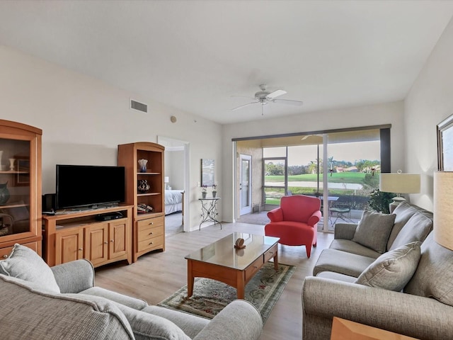 living room with light hardwood / wood-style flooring and ceiling fan