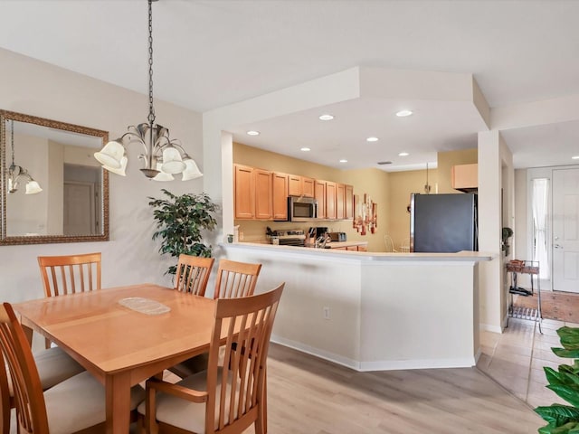 dining room featuring light hardwood / wood-style floors and a notable chandelier