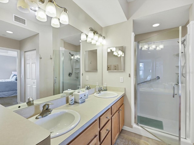 bathroom featuring tile patterned flooring, vanity, and an enclosed shower