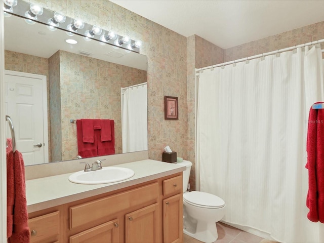 bathroom featuring tile patterned floors, vanity, and toilet