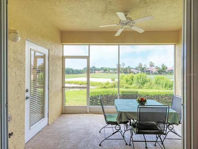 sunroom / solarium featuring ceiling fan and plenty of natural light